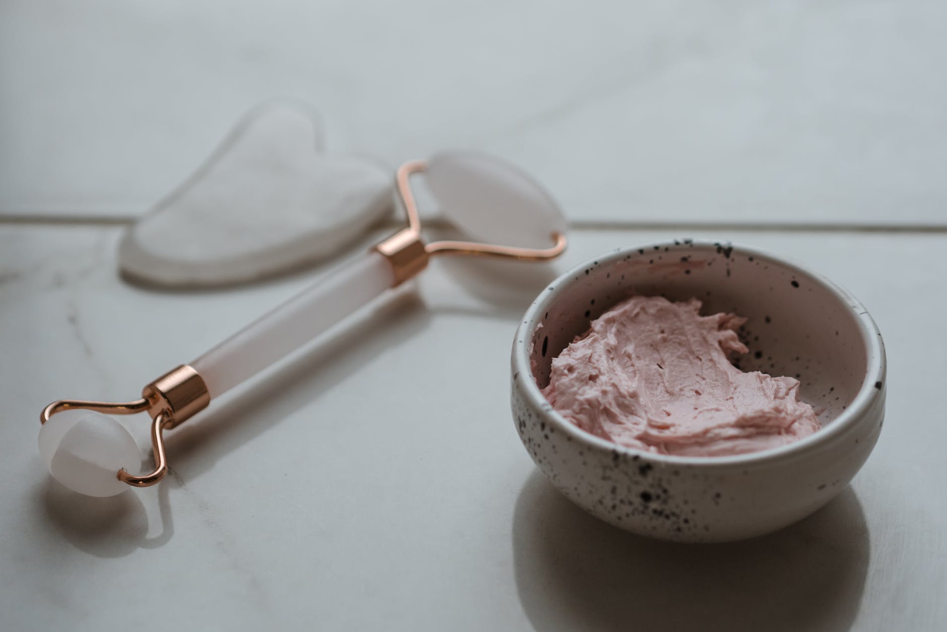 pink ice cream in white ceramic bowl