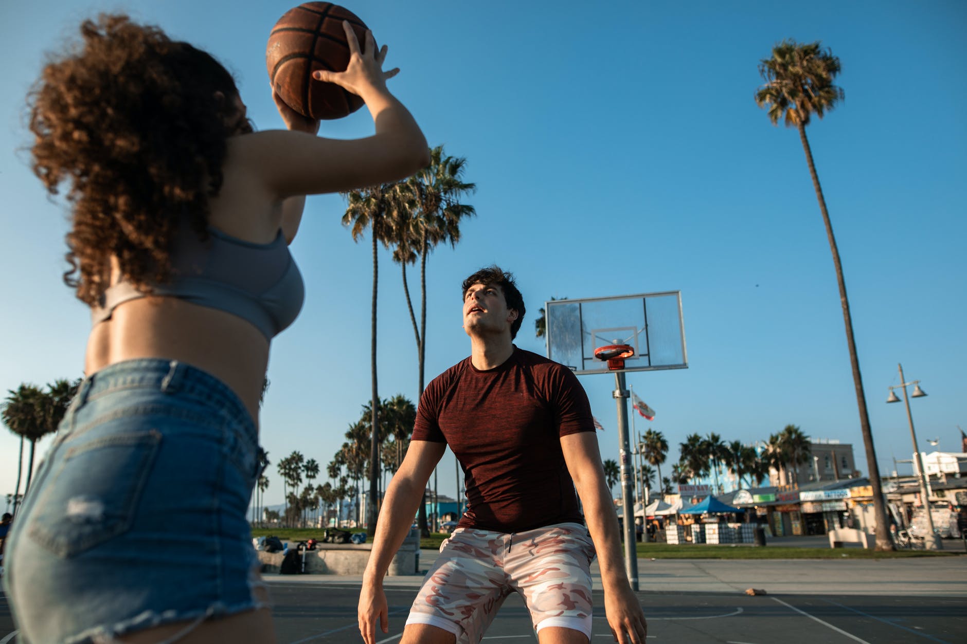man in black tank top and blue denim shorts holding basketball